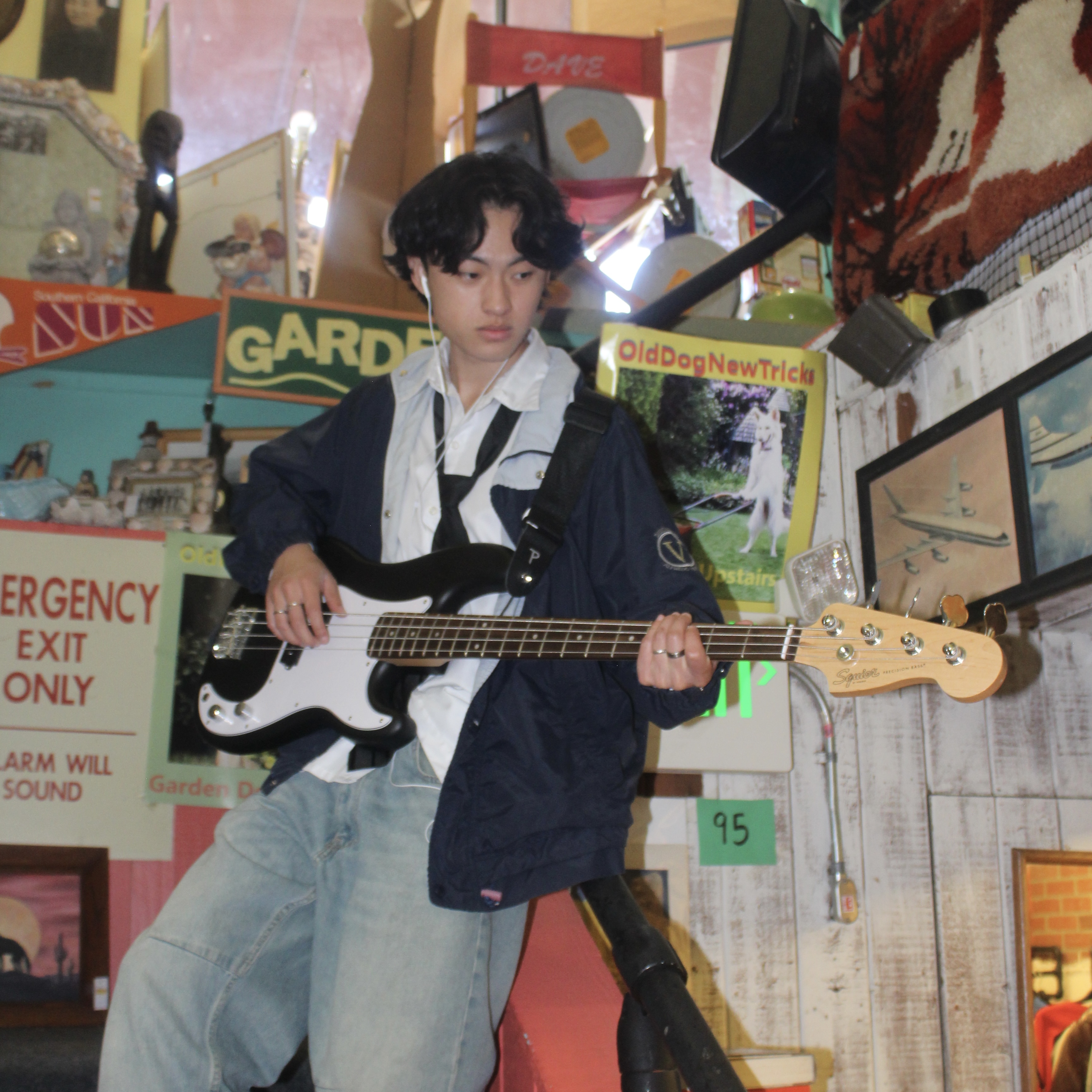 A picture of Aaron with his guitar on the stairs.